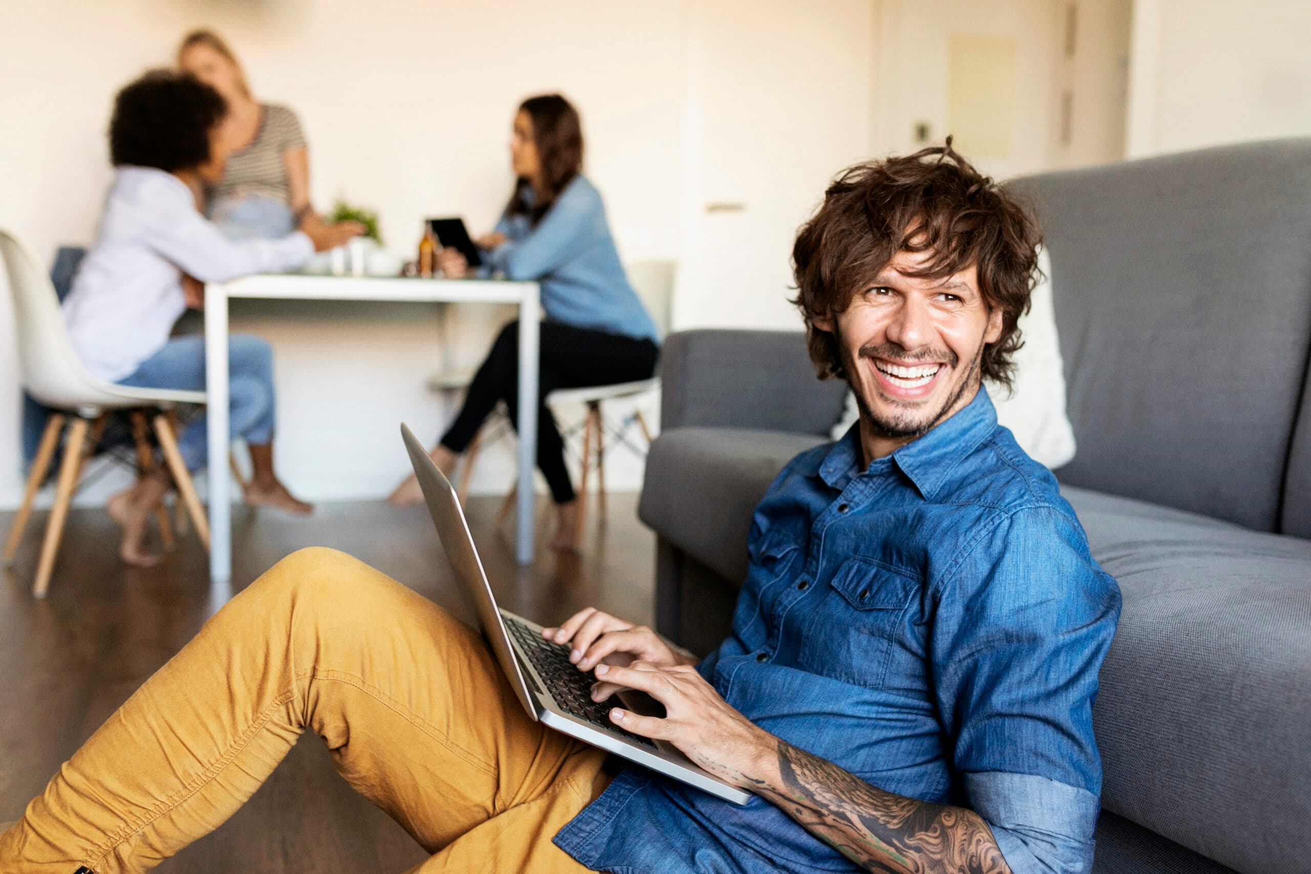homme souriant en tournant la tête de son ordinateur